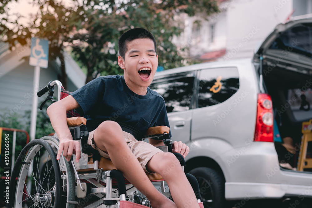 Asian special child on wheelchair beside the car on the parking space for disabled people, Life in the education age and public transport of disabled children, Disability kids transportation concept.