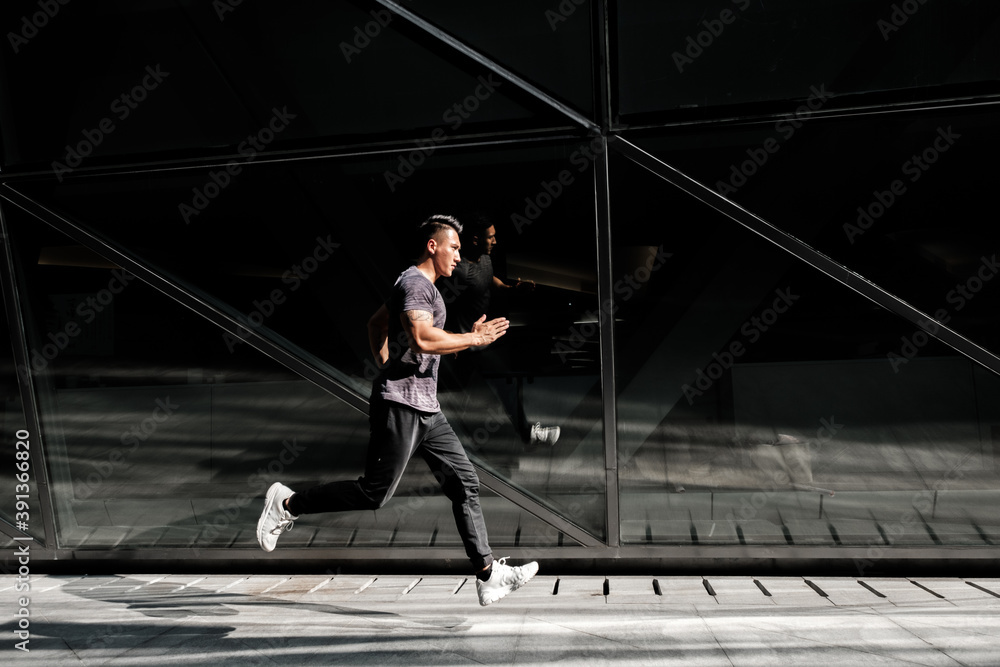 A Chinese man is exercising in the city A Chinese man is exercising in the city