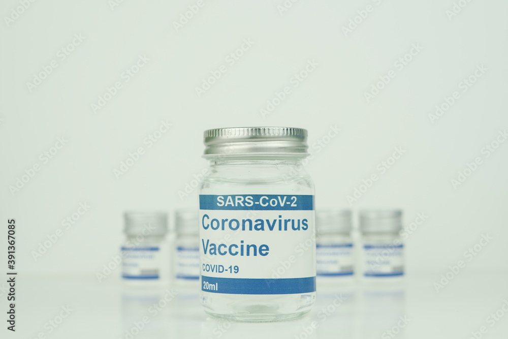 vials with the Covid-19 vaccine on a laboratory bench to combat the coronavirus sars-cov-2 pandemic vials with the Covid-19 vaccine on a laboratory bench to combat the coronavirus sars-cov-2 pandemic