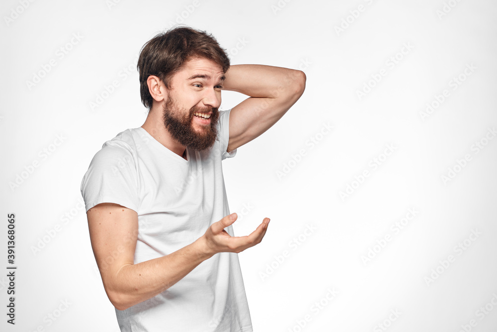 cheerful emotional bearded man gesturing with his hands close-up light background cheerful emotional bearded man gesturing with his hands close-up light background
