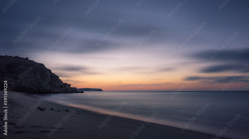 Long exposure of a sunset with colorful sky seascape at Figueira beach in Portugal