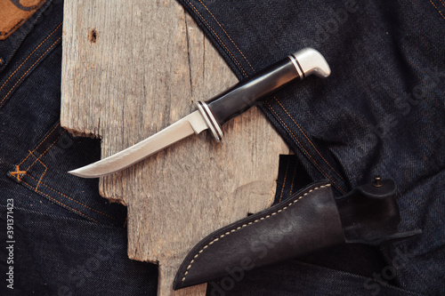 Vintage skinner knife on a piece of wood