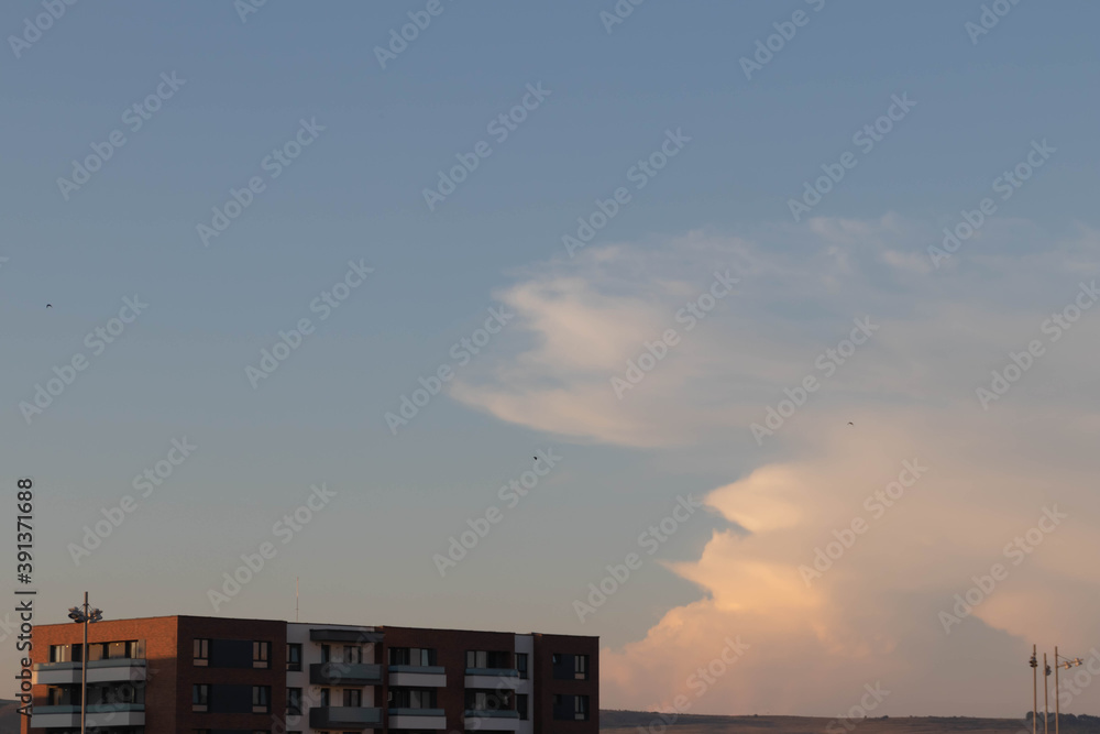 Modern luxury building and the sky with clouds as a background on golden hour Modern luxury building and the sky with clouds as a background on golden hour