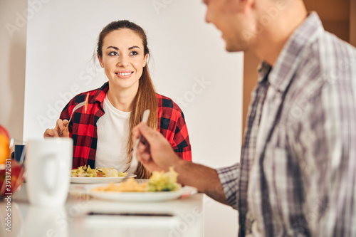 Young couple eating the vegetable salad for breakfast