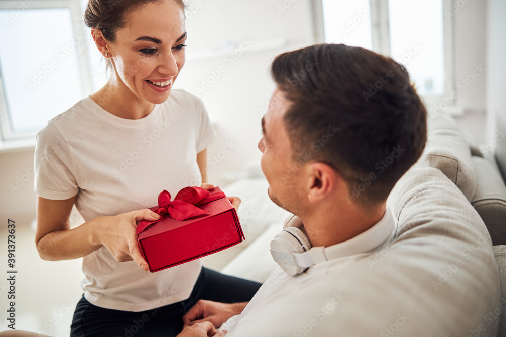 High-spirited wife congratulating her husband on his birthday High-spirited wife congratulating her husband on his birthday