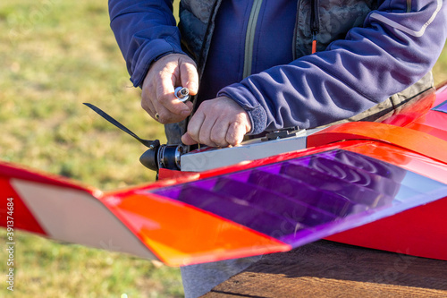 preparations for rc plane take-off, radio-controlled aircraft, male with RC plane