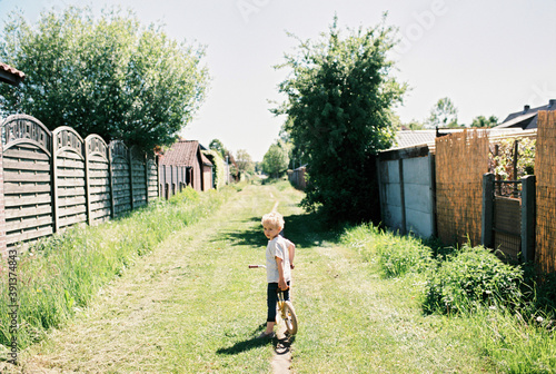 A boy with a yellow bike in the great outdoors photo