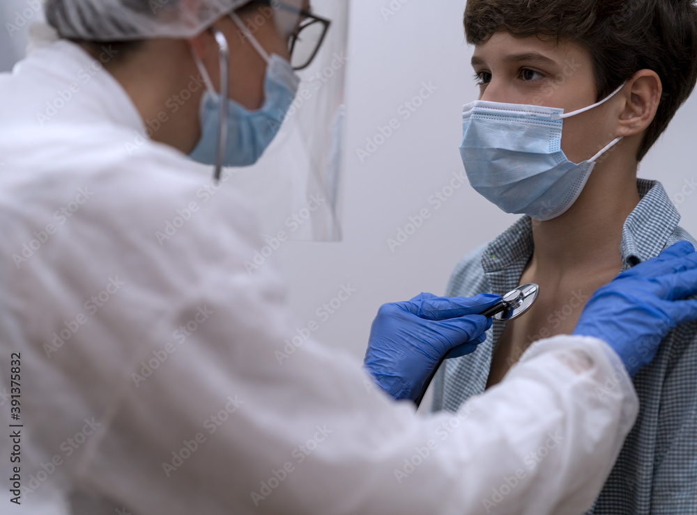 A doctor with a face mask examines a patient with a mask with a stethoscope A doctor with a face mask examines a patient with a mask with a stethoscope
