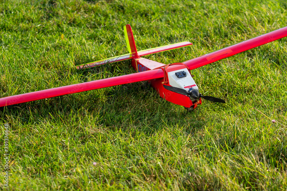radio-controlled aircraft plane on a grassy airport, RC plane on grass,
RC aircraft