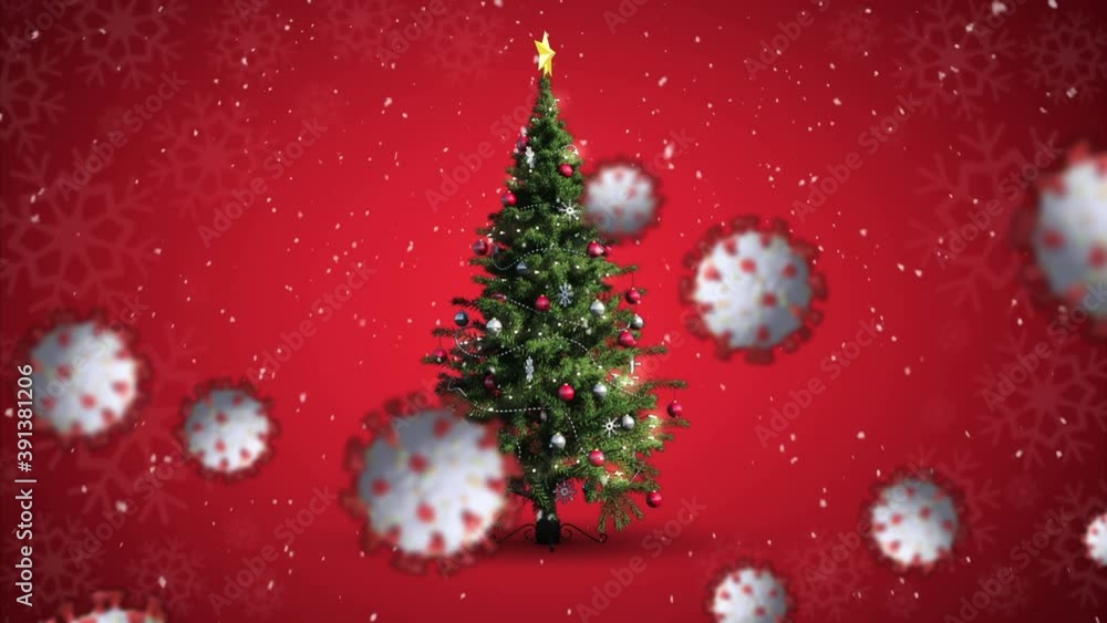 Animation of covid 19 cells moving over winter scenery with christmas tree and snow falling Animation of covid 19 cells moving over winter scenery with christmas tree and snow falling