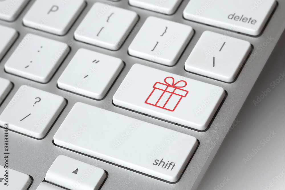 Christmas online shopping. Keyboard with gift symbol key - online Christmas present shopping concept. E-commerce concept. Computer, laptop. Shop online, buy now Christmas online shopping. Keyboard with gift symbol key - online Christmas present shopping concept. E-commerce concept. Computer, laptop. Shop online, buy now