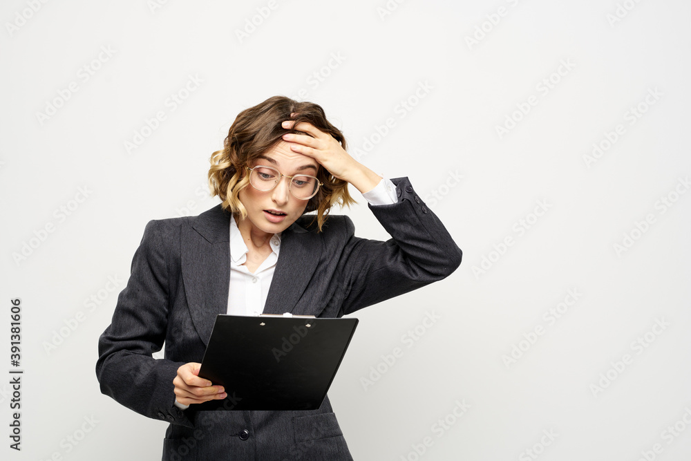 business woman in a suit with documents in hands light background curly hair hairstyle business woman in a suit with documents in hands light background curly hair hairstyle