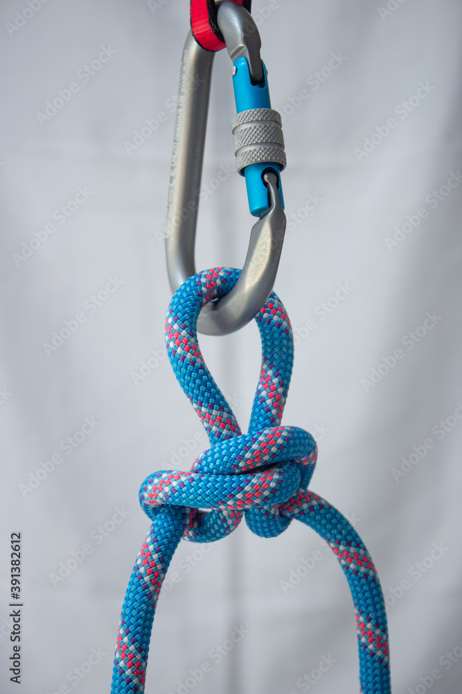 Alpine butterfly knot tied with a climbing rope to a pear shaped ...