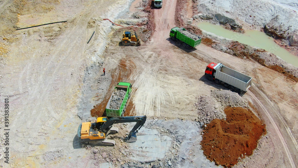 Clay mining. excavator extracts clay and loads into trucks. drone photo.  aerial view foto de Stock | Adobe Stock