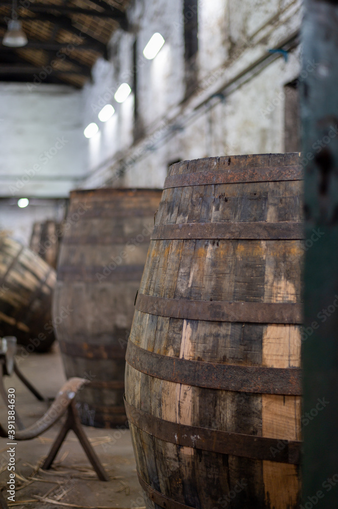 Old porto lodge with rows of oak wooden casks for slow aging of fortified ruby or tawny porto wine in Vila Nova de Gaia, Portugal Old porto lodge with rows of oak wooden casks for slow aging of fortified ruby or tawny porto wine in Vila Nova de Gaia, Portugal