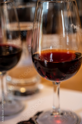 Professional tasting of different fortified dessert ruby, tawny port wines in glasses in porto cellars in Vila Nova de Gaia, Portugal