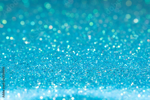 Blue festive glitter background. Shallow depth of field, blurred bokeh effect.