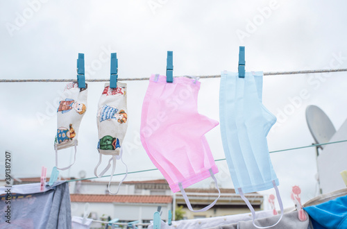 Family washable face masks hanging on a clothesline photo