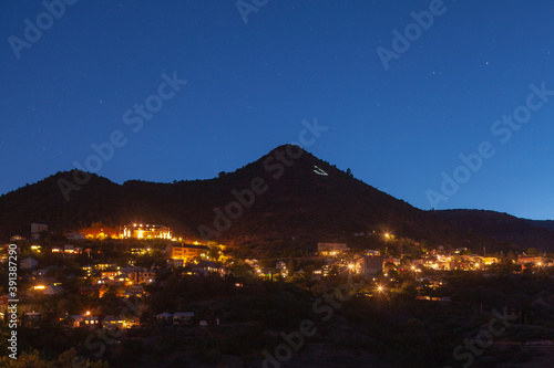 A pulled back view of Jerome Arizona mining town at night lights photo