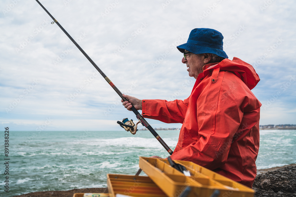 Old man fishing in the sea.