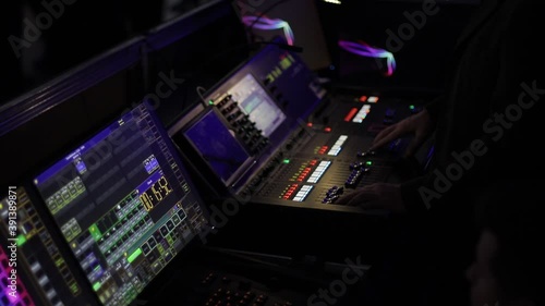 Audio mix desk at a concert. Man working on professional digital audio channel mixer in studio. Male Dj hands playing set in night club party slow motion