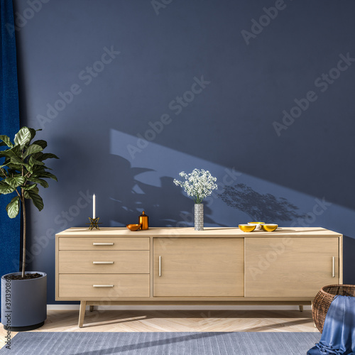 Interior scene in blue color mood: wooden sideboard with flowers, bowls and a candle on top. Fig tree, wicker basket and carpet on hardwood floor - copy space. 3d render photo