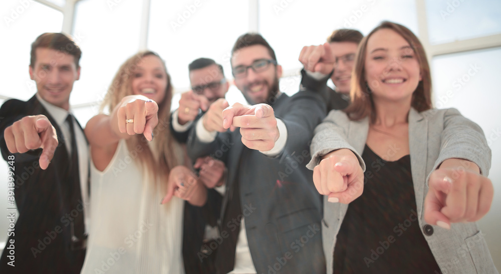 close up.a group of young business people pointing at you close up.a group of young business people pointing at you