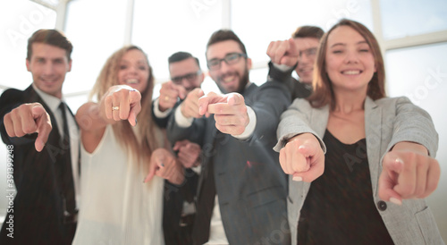 close up.a group of young business people pointing at you