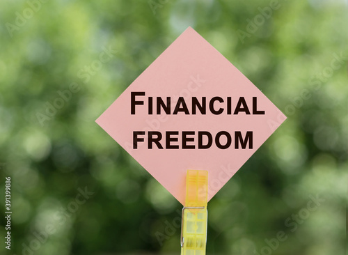 financial freedom text concept on note paper © Nastassia