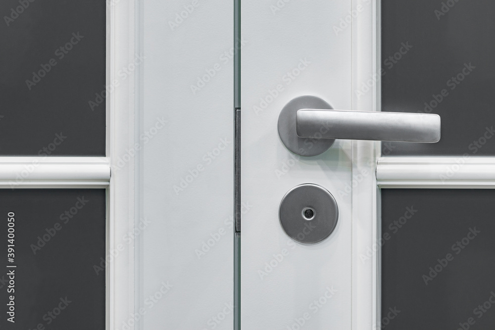 Closeup of metal doorhandle on wooden door. Closeup of metal doorhandle on wooden door.