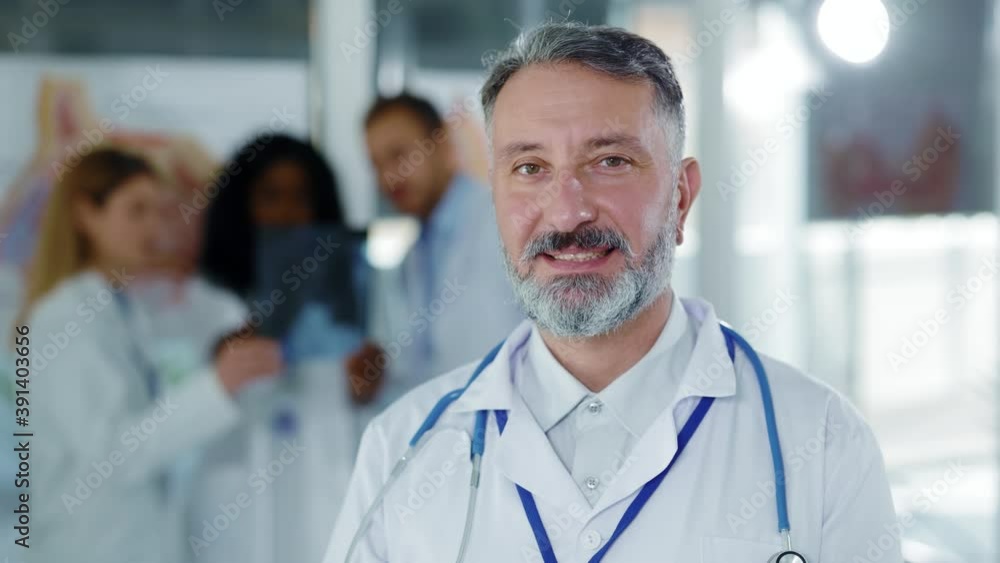Face portrait of middle aged caucasian handsome doctor general practitioner chief therapist smiling cheerfully at camera successful businessman working in hospital. Face portrait of middle aged caucasian handsome doctor general practitioner chief therapist smiling cheerfully at camera successful businessman working in hospital.