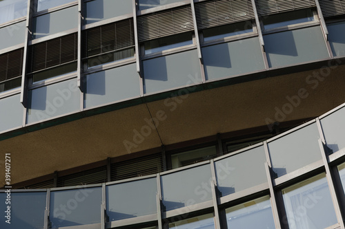 Low angle view and Close-up detail of exterior curvature facade with dark green and grey aluminium composite panels in rectangular shape.