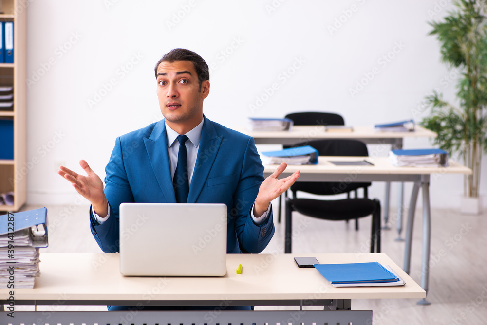 Young businessman employee sitting in the office Young businessman employee sitting in the office