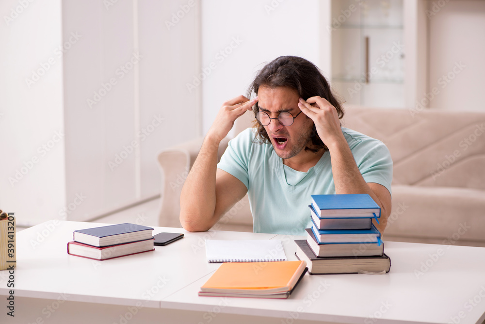 Young male student preparing for exams at home Young male student preparing for exams at home
