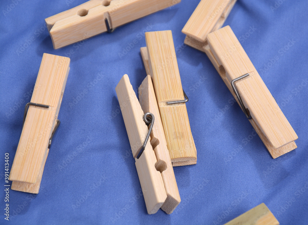 Wooden clothes pin. Closeup pin set on blue background Wooden clothes pin. Closeup pin set on blue background