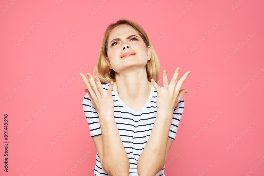 Woman in striped t-shirt emotions studio cropped view lifestyle pink isolated background
