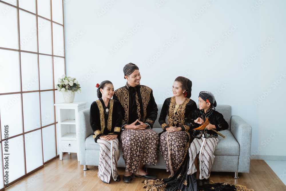 Portrait of a happy family wearing traditional Javanese clothes. concept of family photo Javanese traditional clothes in the living room - obrazy, fototapety, plakaty 