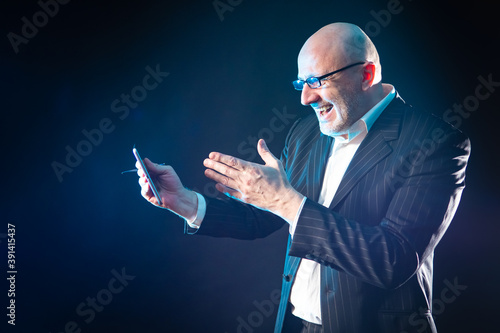 Joy. Cheerful man with a ph...