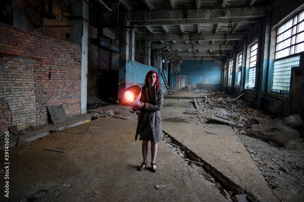 Girl in the factory in a coat 