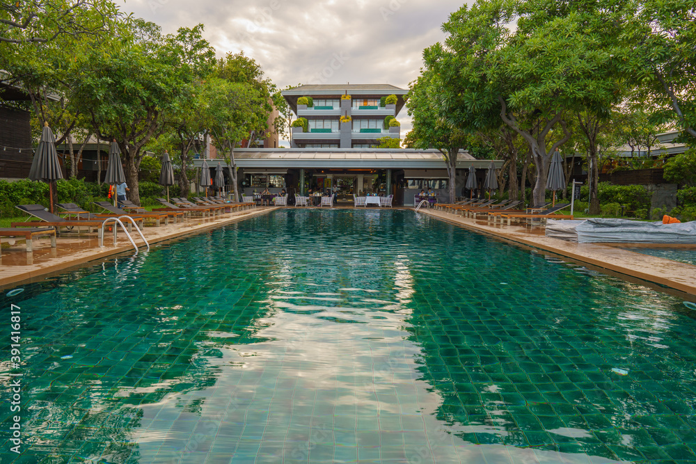 beachfront resort and hotel with foreground of swimming pool