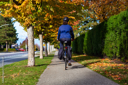 Girl Riding a Bicycle on a Sidewalk in a calm neighborhood. Taken in Fraser Heights, Surrey, Vancouver, BC, Canada. © edb3_16