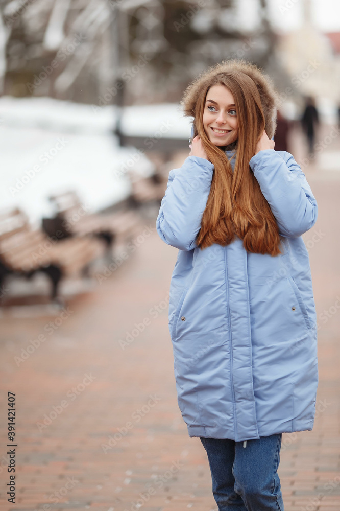 young woman are walking in the winter park. Winter park in the snow. Clothing advertising photo concept