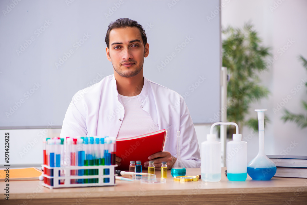 Young male chemistry teacher in the classroom Young male chemistry teacher in the classroom