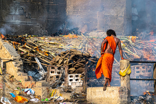an indian monk(aghori) satanding at the holy Manikarnika ghat at Varanasi,Cremation ceremony in Manikarnika photo