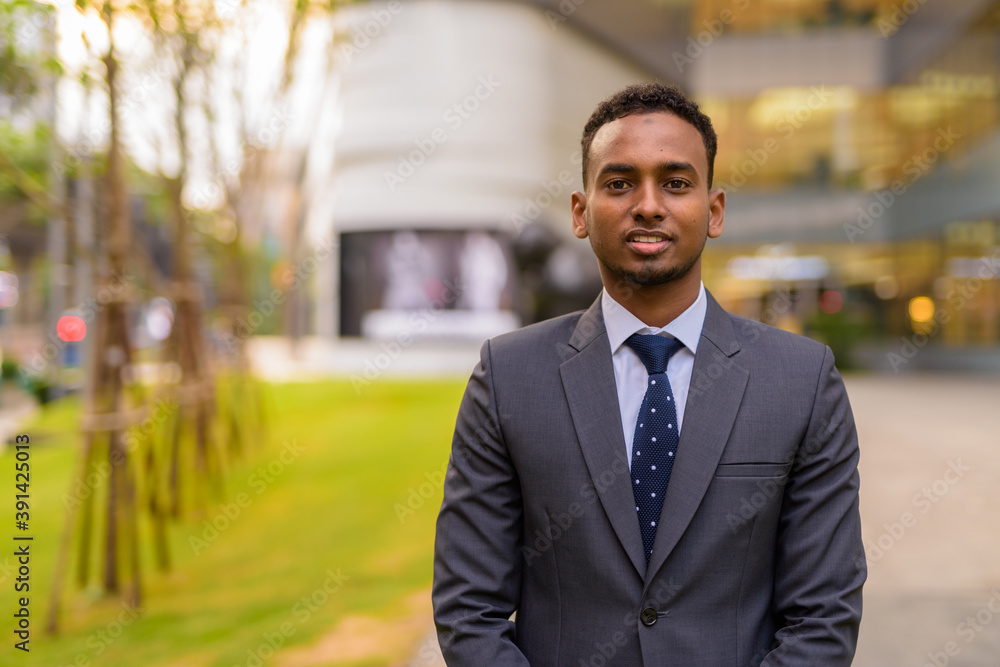 Portrait of young handsome African businessman outdoors Portrait of young handsome African businessman outdoors
