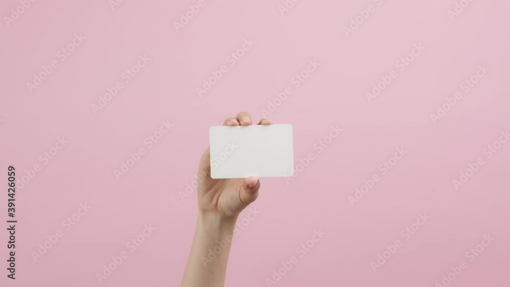 Hand holding credit cards and showing on the pink background. Hand holding credit cards and showing on the pink background.