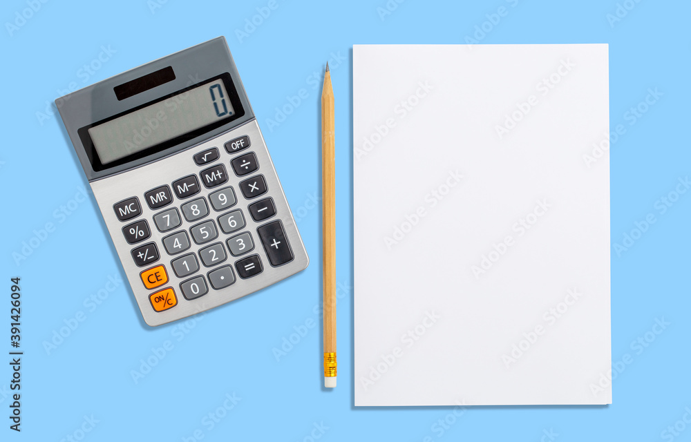 Notepaper with pencil and green power office desktop calculator with solar cell power isolated on blue background with path. Notepaper with pencil and green power office desktop calculator with solar cell power isolated on blue background with path.