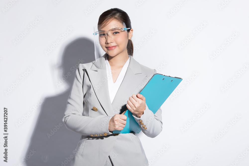 Business woman wearing face shield, isolated on white studio background Business woman wearing face shield, isolated on white studio background