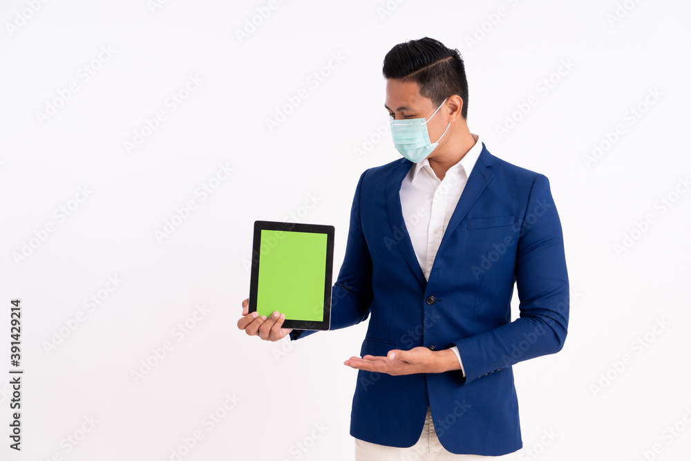 Portrait of a happy businessman. Showing copy space on the tablet with masks for health Portrait of a happy businessman. Showing copy space on the tablet with masks for health