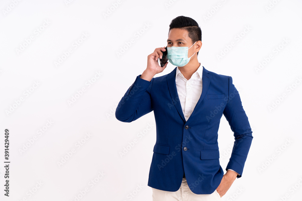 Portrait of a busy businessman. Viewing his project on a phone with masks for health Portrait of a busy businessman. Viewing his project on a phone with masks for health